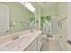 Bathroom featuring double sinks, quartz countertop, and a stylish shower curtain at 17152 Scuba Crest St, Wimauma, FL 33598