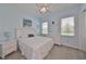 Serene bedroom featuring light blue walls, plush carpet, a comfortable bed, and well-lit windows for a relaxing ambiance at 17152 Scuba Crest St, Wimauma, FL 33598