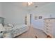 Bright bedroom with inviting decor, soft carpet, and access to bathroom, provides a peaceful and stylish retreat at 17152 Scuba Crest St, Wimauma, FL 33598