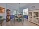 Charming dining room featuring blue walls, decorative china cabinets, and a Tiffany-style pendant light fixture at 17152 Scuba Crest St, Wimauma, FL 33598