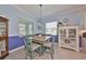 Cozy dining room featuring beadboard, a stained glass light fixture, and ample natural light at 17152 Scuba Crest St, Wimauma, FL 33598