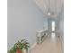 Light blue entryway features ceramic tile flooring, a console table, and a decorative light fixture at 17152 Scuba Crest St, Wimauma, FL 33598