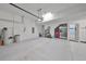Spacious garage with water filtration system, refrigerator, and ample storage space at 17152 Scuba Crest St, Wimauma, FL 33598