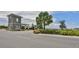 Welcome to the community! View of the gate house featuring stone accents and lush landscaping at 17152 Scuba Crest St, Wimauma, FL 33598