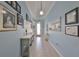 Hallway featuring tile floors, console tables, decorative items, and recessed lighting at 17152 Scuba Crest St, Wimauma, FL 33598