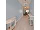 Hallway featuring console tables, tile floors, and leading into the living room at 17152 Scuba Crest St, Wimauma, FL 33598