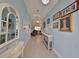 Hallway featuring tile floors, console tables, decorated walls, and recessed lighting at 17152 Scuba Crest St, Wimauma, FL 33598