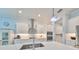 Bright kitchen with stainless appliances, white cabinets, and a large center island with a sink at 17152 Scuba Crest St, Wimauma, FL 33598