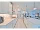 Bright kitchen features long white countertops, stainless steel appliances, and lots of cabinet space at 17152 Scuba Crest St, Wimauma, FL 33598