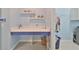 Functional laundry room features a spacious folding counter and organized storage solutions at 17152 Scuba Crest St, Wimauma, FL 33598