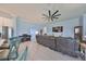 Open-concept living space with ceramic floors, leather sectional and light blue walls at 17152 Scuba Crest St, Wimauma, FL 33598