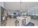 Spacious kitchen open to the living room with stainless steel appliances and light blue walls at 17152 Scuba Crest St, Wimauma, FL 33598