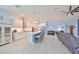 Bright, open layout with living room, kitchen, recessed lighting, and island with barstool seating at 17152 Scuba Crest St, Wimauma, FL 33598
