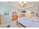 Bright bedroom with trey ceiling, hardwood floors, ceiling fan, and modern decor at 17152 Scuba Crest St, Wimauma, FL 33598