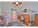 Bright office space with two work areas, ceiling fan, and access to a private bathroom, perfect for productivity at 17152 Scuba Crest St, Wimauma, FL 33598