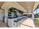 Outdoor community bar featuring a large countertop, several TVs, and plenty of seating at 17152 Scuba Crest St, Wimauma, FL 33598