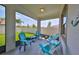 This is a screened patio with comfortable seating and views of the backyard and landscaping at 17152 Scuba Crest St, Wimauma, FL 33598