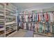 Spacious walk-in closet featuring custom built-in shelving and ample hanging space for organized storage at 17152 Scuba Crest St, Wimauma, FL 33598