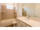 Bathroom featuring quartz counters, a window, a tiled shower over tub, and white cabinets at 17406 Isaac Ln, Punta Gorda, FL 33955