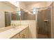Bathroom with quartz counters, a glass enclosed shower, and gray subway tile surround at 17406 Isaac Ln, Punta Gorda, FL 33955