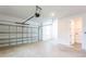 Spacious two-car garage featuring a garage door opener, concrete floors, and a door to the laundry room at 17406 Isaac Ln, Punta Gorda, FL 33955