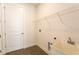 Laundry room featuring a utility sink, door to garage, and wire shelving at 17406 Isaac Ln, Punta Gorda, FL 33955