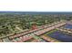 Expansive aerial view of a residential area, highlighting homes with red roofs and community ponds at 17418 Holly Well Ave, Wimauma, FL 33598
