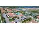 Aerial view of a community with a pool, tennis courts, and well-maintained landscaping at 17418 Holly Well Ave, Wimauma, FL 33598