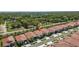 Aerial view showcases a suburban neighborhood with well-manicured lawns and tree-lined streets at 17418 Holly Well Ave, Wimauma, FL 33598