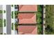 Aerial view of homes with red tile roofs and green lawns in a well-planned community at 17418 Holly Well Ave, Wimauma, FL 33598