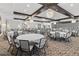 This banquet room is complete with modern chandeliers, tables and chairs for any event at 17418 Holly Well Ave, Wimauma, FL 33598