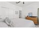 Bright bedroom with neutral colors, ceiling fan, and view of the ensuite bathroom at 17418 Holly Well Ave, Wimauma, FL 33598