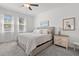 Bright main bedroom boasts soft carpet, a comfortable queen bed, and plenty of natural light at 17418 Holly Well Ave, Wimauma, FL 33598