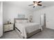Bright main bedroom features soft carpet, a comfortable queen bed, and ensuite bathroom at 17418 Holly Well Ave, Wimauma, FL 33598