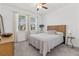 Cozy bedroom with a ceiling fan, plush carpet and large windows that let in natural light at 17418 Holly Well Ave, Wimauma, FL 33598