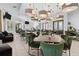 The clubhouse dining room features modern lighting, elegant tables and seating at 17418 Holly Well Ave, Wimauma, FL 33598