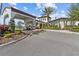 Elegant community entrance featuring a porte cochere and beautifully landscaped surroundings at 17418 Holly Well Ave, Wimauma, FL 33598