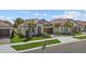 Charming single-story home with a tiled roof, manicured lawn, and inviting curb appeal at 17418 Holly Well Ave, Wimauma, FL 33598