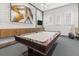 This game room has a pool table, modern decor, and a TV at 17418 Holly Well Ave, Wimauma, FL 33598