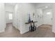 Elegant hallway with decorative wood trim, modern console table, and wood-look tile flooring at 17418 Holly Well Ave, Wimauma, FL 33598