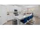 Bright kitchen featuring white cabinets, stainless steel appliances, and a quartz countertop island with bar seating at 17418 Holly Well Ave, Wimauma, FL 33598