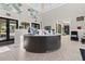 This lobby features high ceilings, modern decor, and ample natural light at 17418 Holly Well Ave, Wimauma, FL 33598