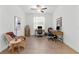 Bright home office with dual workstations, wood-look tile flooring, and ample natural light at 17418 Holly Well Ave, Wimauma, FL 33598