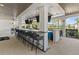 This outdoor bar includes comfortable seating, TVs and a clear view of the property at 17418 Holly Well Ave, Wimauma, FL 33598