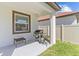 This outdoor patio has a barbecue grill and a view of the home's exterior at 17418 Holly Well Ave, Wimauma, FL 33598