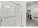 Modern walk-in shower with white subway tile, glass door, and convenient grab bar at 17418 Holly Well Ave, Wimauma, FL 33598