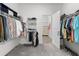 Spacious walk-in closet with ample shelving and hanging space for organized storage at 17418 Holly Well Ave, Wimauma, FL 33598