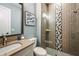 Modern bathroom featuring a walk-in shower with decorative tile and a sleek vanity with a vessel sink at 17716 Roost Pl, Lakewood Ranch, FL 34211