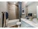 Well-lit bathroom with a bathtub, shower, and a vanity with a marble countertop at 17716 Roost Pl, Lakewood Ranch, FL 34211