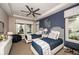 Stylish bedroom with two twin beds, a ceiling fan, and large windows providing natural light at 17716 Roost Pl, Lakewood Ranch, FL 34211
